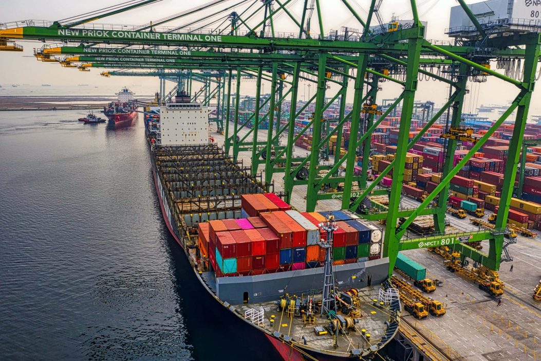 An aerial image of a container ship docked in a port